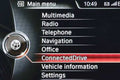BMW NBT infotainment system menu with options like Multimedia, Radio, Telephone, Navigation, etc.