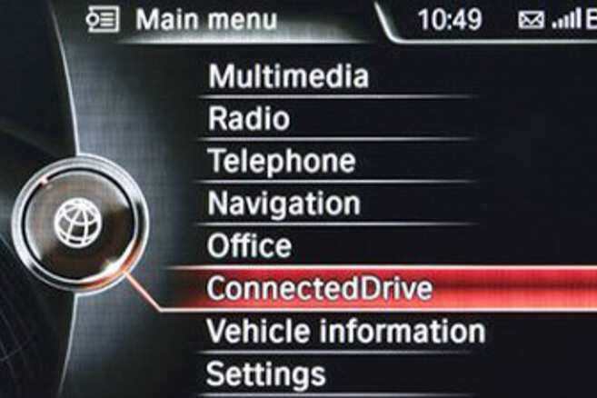 BMW NBT infotainment system menu with options like Multimedia, Radio, Telephone, Navigation, etc.